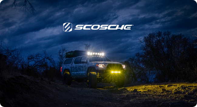 Truck driving off-road at night with lights on
