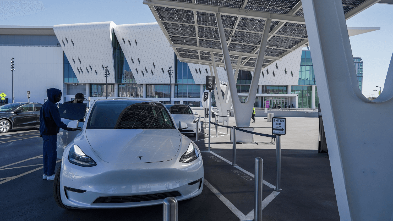 White Tesla outside of a building