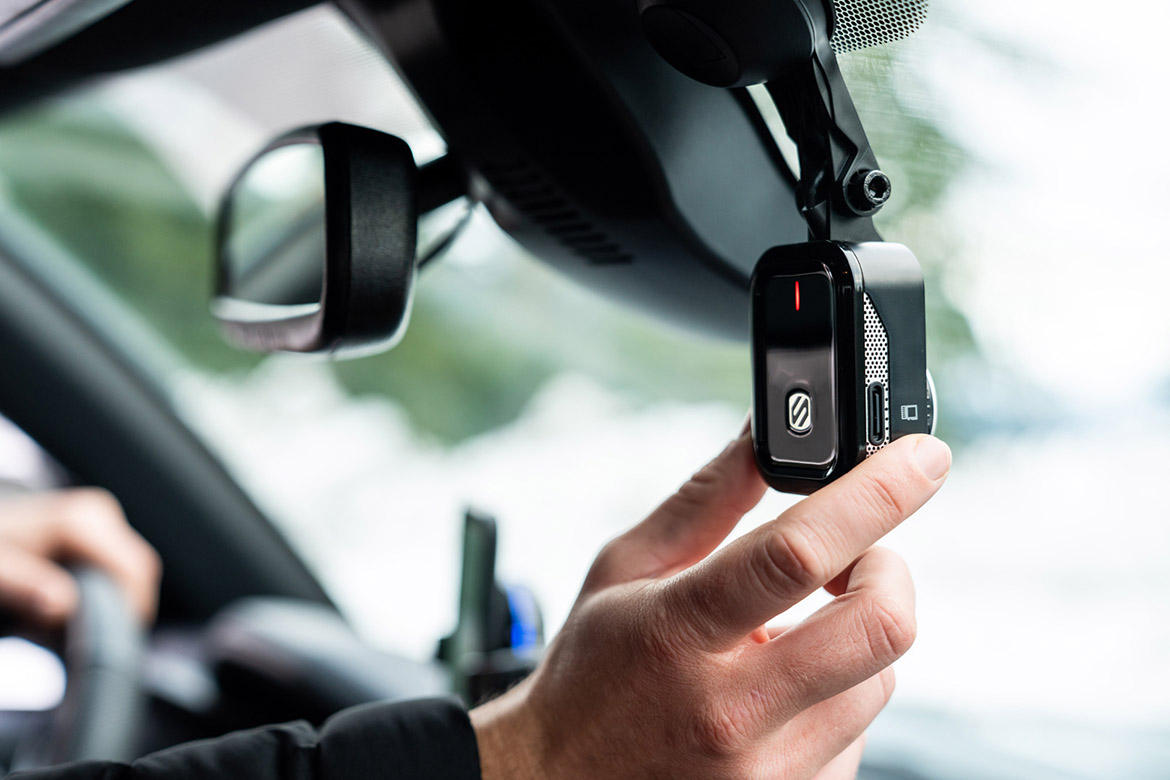 man adjusting Scosche dash cam