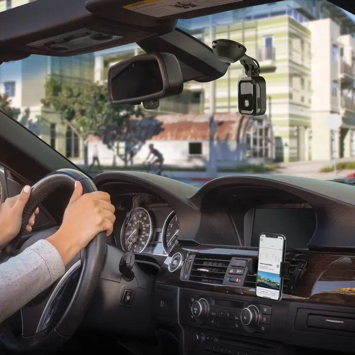 woman driving with nexs1 smart dash camera on car windshield