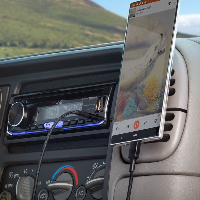 phone charging on a car dashboard